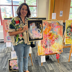 Betina Karolyi with her paintings, at the Headquarters exhibition